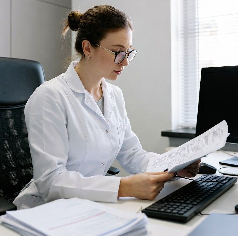 female dentist reviewing financial documents in a modern clinic office